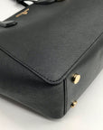 Black handbag with gold accents on a white background