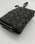 Black patterned wallet with a zipper on a white background