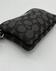 Black patterned wallet with a tag on a light gray background