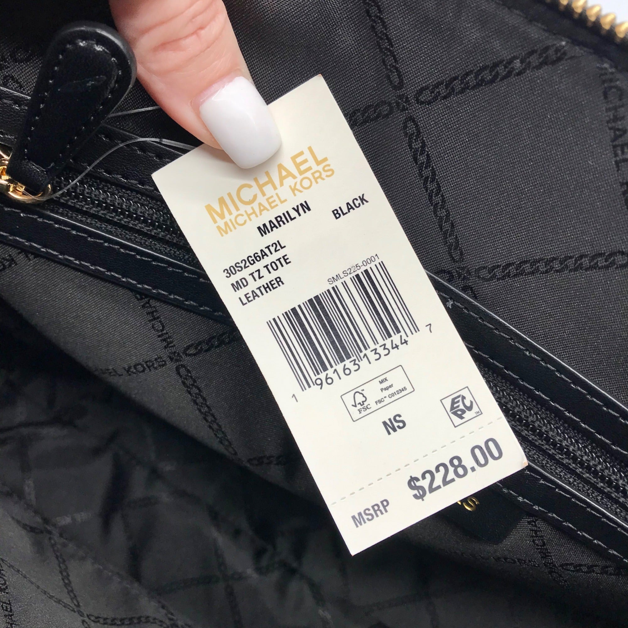 Michael Kors tote bag with a price tag showing $228.00